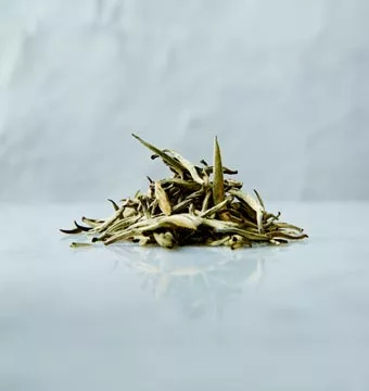 Large white tea leaves on a marbled surface