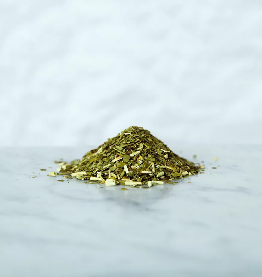A collection of Yerba Mate Leaves on a marbled surface